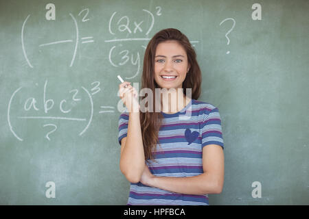 Portrait of schoolgirl pretending to be a teacher in classroom at school Stock Photo