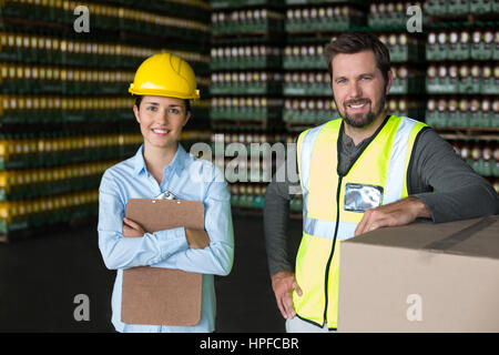 Portrait of smiling factory workers standing in factory Stock Photo