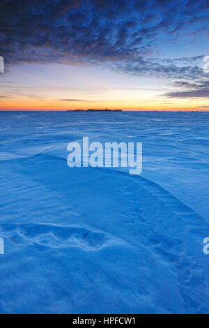 Winter sunset on snow covered fields in Manitoba, Canada Stock Photo