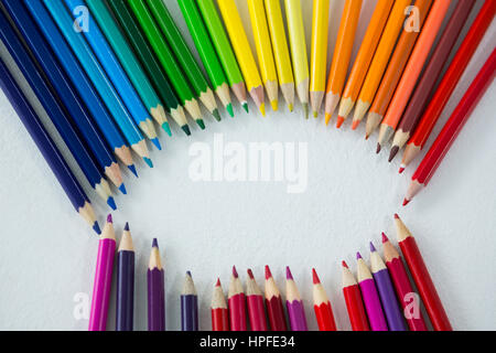 Close-up of colored pencils arranged in circle on white background Stock Photo