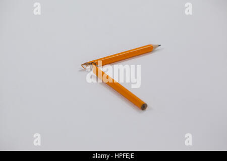 Close-up of broken pencil on white background Stock Photo