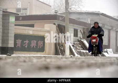 Liaocheng, China. 22nd Feb, 2017. A Woman Walks On Slippery Road With 