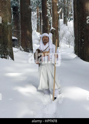 The Japanese Yamabushi mountain ascetic Takehiro Miura holds a conch in snow-covered forest in the Yamagata Province, Japan, 15 February 2017. Monks and members of the laity have retreated into the mountains in the area to live a life immersed in ascetic rituals and prayer for some 1300 years. Photo: Lars Nicolaysen/dpa Stock Photo