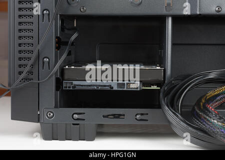 Internal hard drive inserted in computer case. Stock Photo