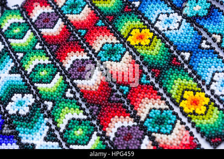 Huichol art. Beaded bracelets and jewelry. Colorful patterns. Background Stock Photo