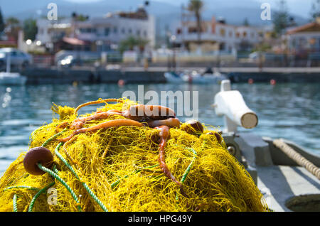 Fresh octopus on yellow fishing nets, in a traditional fishing boat, Crete, Greece. Stock Photo