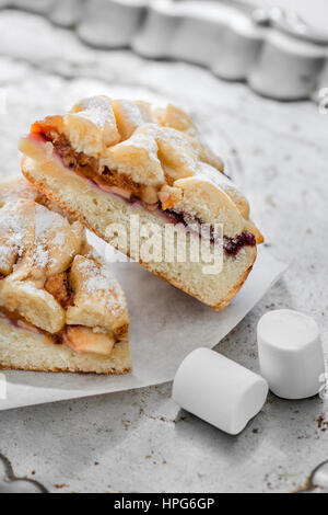 Sweet homemade cake with jam and fruit on a tray of silver cut into chunks Stock Photo