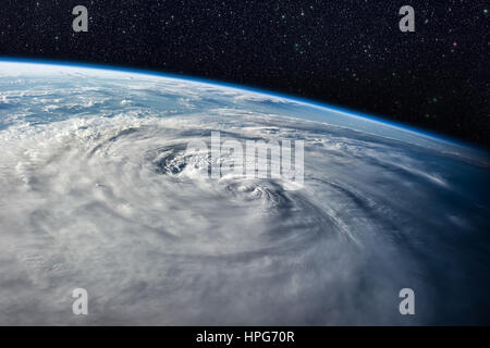 Typhoon over planet Earth - satellite photo. Elements of this image furnished by NASA. Stock Photo