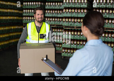 Factory workers interacting with each other in factory Stock Photo
