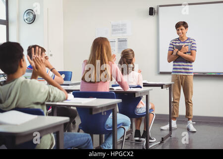 Schoolboy giving presentation in classroom at school Stock Photo - Alamy