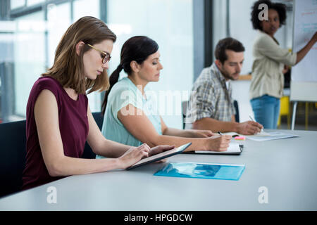 Business executive using digital tablet in meeting at office Stock Photo
