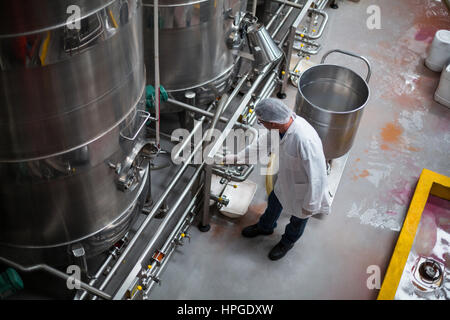 Factory engineer monitoring storage tank in bottle factory Stock Photo
