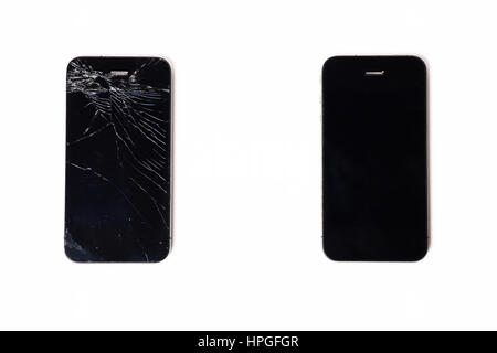 Black broken and non-broken sell phones on white background Stock Photo