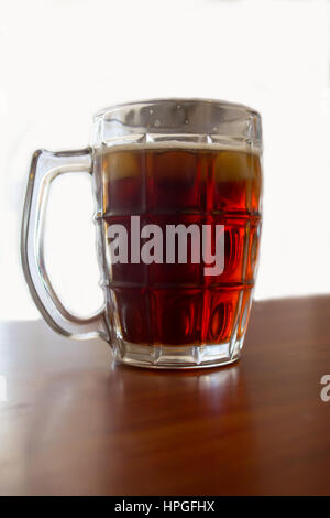 View of a glass of dark beer against a white background Stock Photo