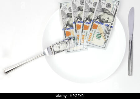 Isolated hundred-dollars  bills on a plate Stock Photo