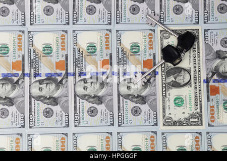 Keys are lying on one-dollar bills. Isolated Stock Photo