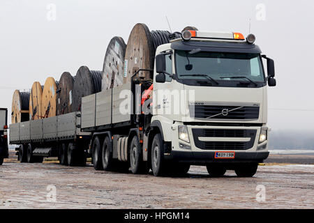 SALO, FINLAND - FEBRUARY 17, 2017: White Volvo FH truck with Reka power cable drums on open trailer parked on working site in winter. Stock Photo