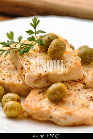 Cod fish with green olives Stock Photo