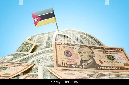 The national flag of Mozambique sticking in a pile of american dollars.(series) Stock Photo