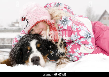 Maedchen mit Hund im Schnee - girl with dog in snow, Model released Stock Photo