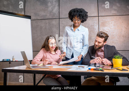 Coworkers working together indoors Stock Photo