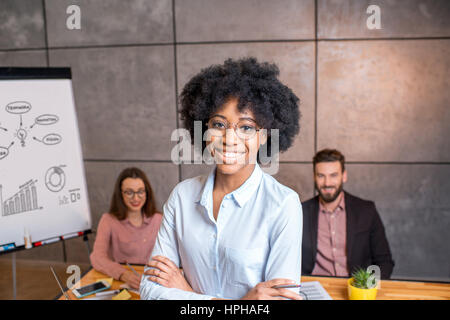 Woman's portrait with coworkers Stock Photo
