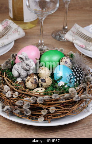Easter colored eggs scattered on a green moss as an element of a holiday decoration ideas Stock Photo