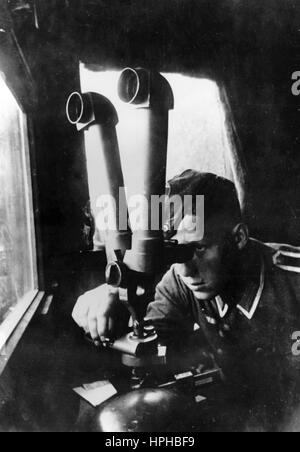 The Nazi propaganda image shows a soldier from a German Wehrmacht battery on a twin telescope on the Western Front. Published in October 1940. A Nazi reporter has written on the reverse of the picture on 12.10.1940, 'The eyes of the battery. The twin telescope has been trained on the enemy, who will no longer be let out of sight.' Fotoarchiv für Zeitgeschichte - NO WIRE SERVICE - | usage worldwide Stock Photo