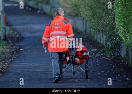 Royal Mail postman delivering letters with trolley Stock Photo