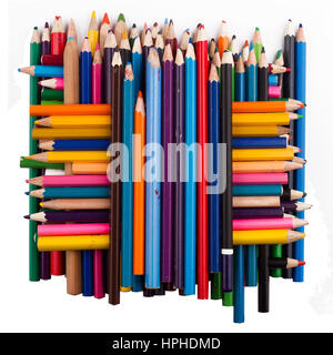 Top view of many colored pencils arranged in a pile on top of each other isolated on white background Stock Photo
