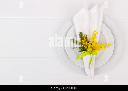 Spring table setting with mimosa. Holidays background with copy space Stock Photo