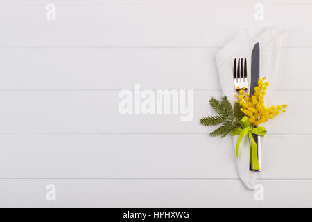 Spring table setting with mimosa. Holidays background with copy space Stock Photo