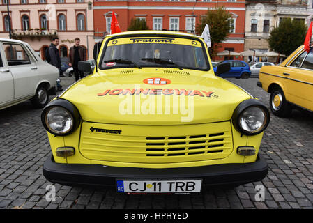 CLUJ-NAPOCA, ROMANIA - OCTOBER 15, 2016: Yellow Trabant and other vintage cars exhibited during the Retro Mobile Autumn Parade in the city of Cluj Nap Stock Photo