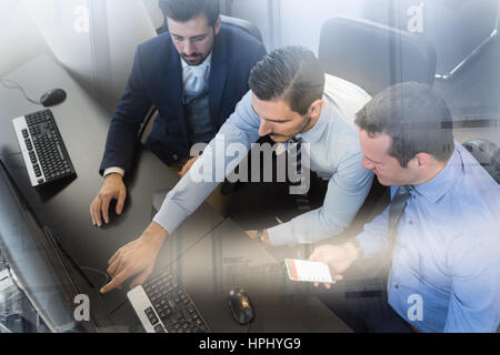 Business team analyzing data on computer. Stock Photo