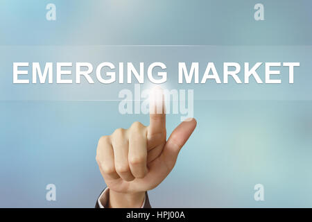 business hand pushing emerging market button on blurred background Stock Photo