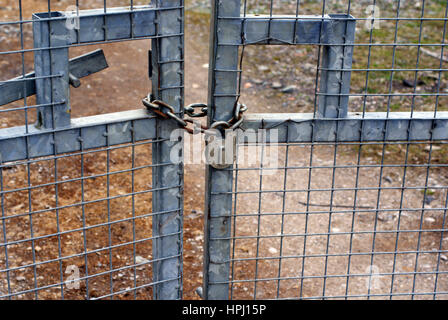 Set of locked padlocked security gates at an industrial or commercial premises Stock Photo