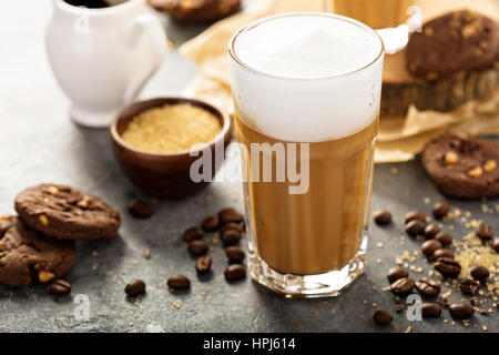 Hot latte with thick foam and chocolate syrup in tall glasses Stock Photo