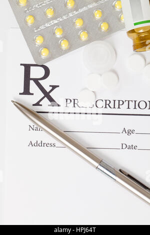 Pills and pen over medical prescription form Stock Photo