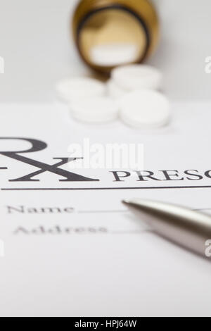 Pen and some pills over medical prescription form Stock Photo