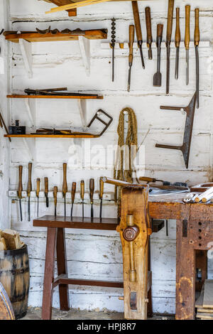 Vintage carpentry tools hanging on wall. Stock Photo