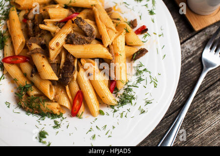 Tasty penne pasta recipe with beef meat. Italian pasta ala puttanesca Stock Photo