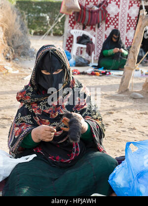 Muscat, Oman, February 4th, 2017: omanya making yarn out of wool Stock Photo