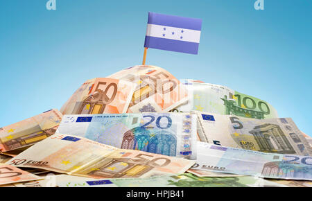 The national flag of Honduras sticking in a pile of mixed european banknotes.(series) Stock Photo