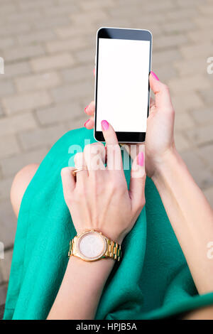 Smartphone in hands of fashionable woman. Mock up blank screen phone. Shallow depth of field Stock Photo