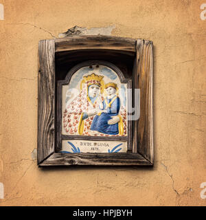 Image of a pictorial ceramic tile inside a building niche. Bologgna, Italy. Stock Photo