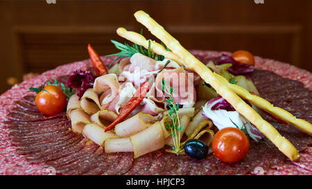 Assorted meats and sausages, olives and spices, close-up Stock Photo