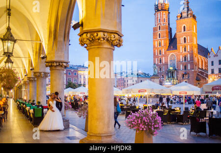 St Mary's Basilica, from arcade of Cloth Hall, at Main Market Square Rynek Glowny, Krakow, Poland Stock Photo