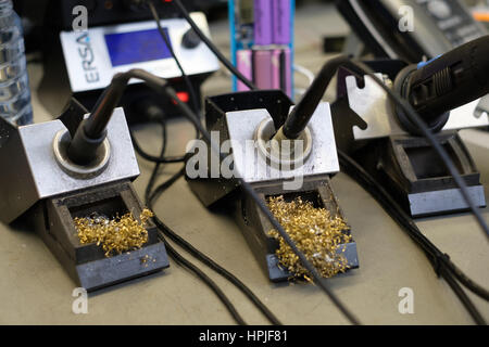 Soldering irons on stands Stock Photo