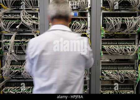 Data center technician working in the server room Stock Photo