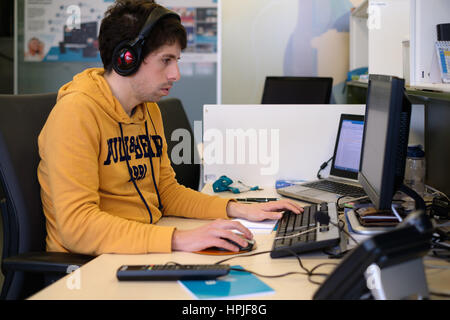 Young man working at the computer Stock Photo